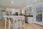 Well equipped kitchen with stainless steel appliances and breakfast bar